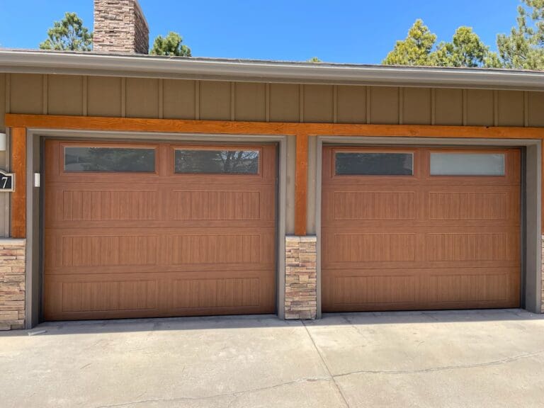 Brown Residential Sectional garage door with glass after installation by Overhead Door Company of Rapid City.