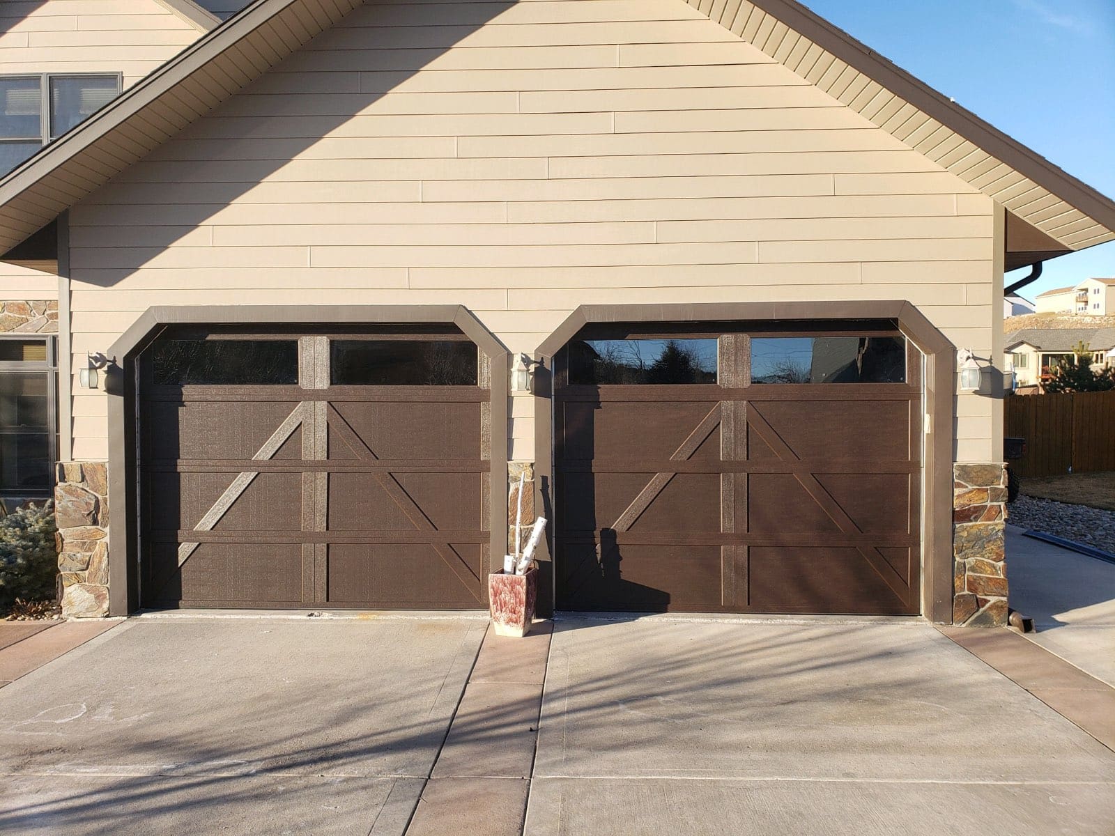 Dark brown panel residential garage door after installation by Overhead Door of Rapid City.