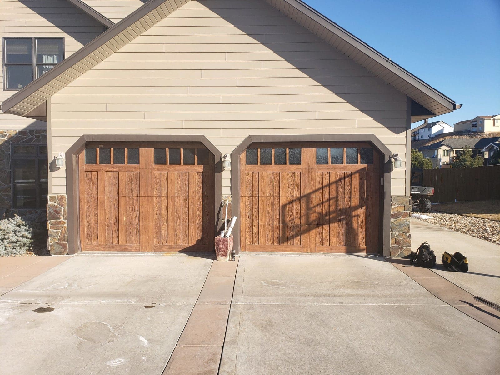 Light brown panel residential garage door with glass before installation by Overhead Door of Rapid City.