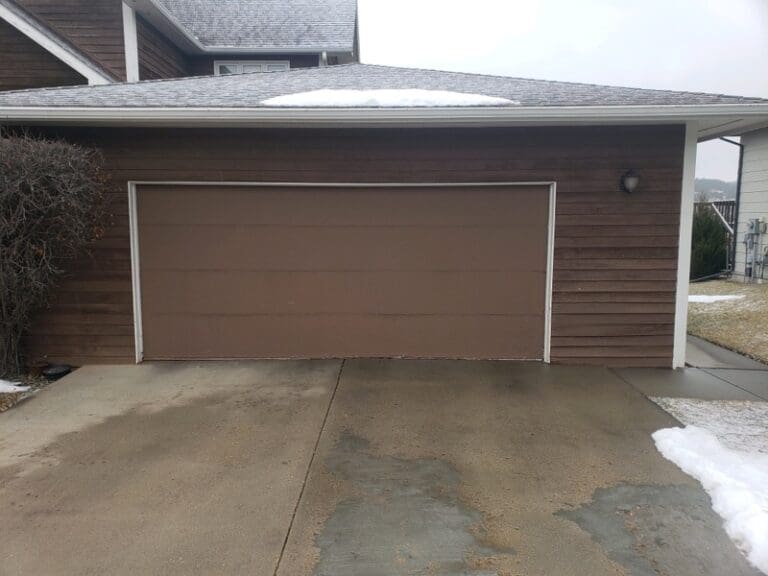 Tan Residential Sectional Garage Door without glass before installation by Overhead Door of Rapid City.