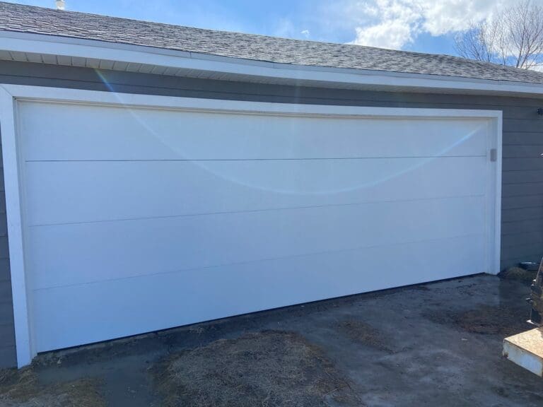 White residential sectional garage door after installation by Overhead Door Company of Rapid City.