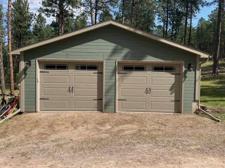 After of cream colored 2 door 2 car garage with more modern look