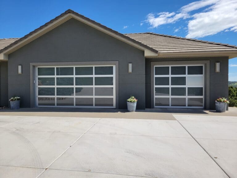 after of a double car garage door and a single car garage door on a house with glass panels
