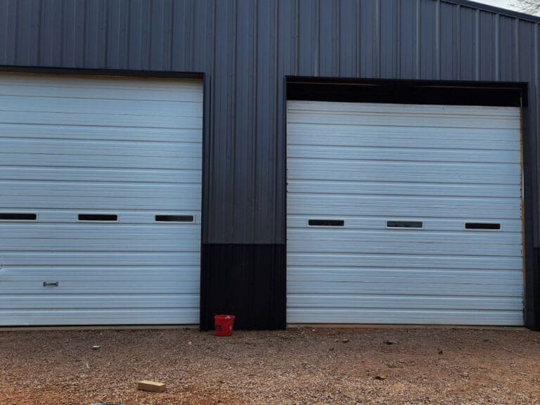 Before photos of two large metal garage doors with one missing a panel