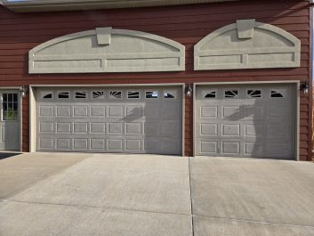 old residential garage door that is warping and fading