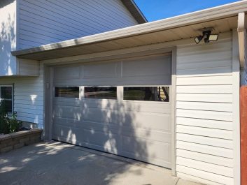 After of updated taupe colored 1.5 car garage with new windows