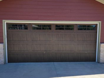 Red residential home with updated garage door - After