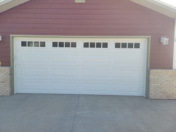 Red residential home with white outdated door - Before