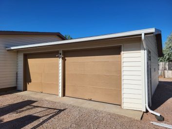 Before of dated tan 2 door 2 car garage