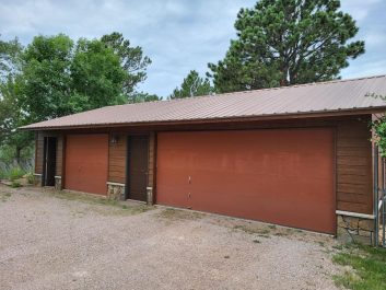 Before of dated burnt orange 2 door 3 car garage