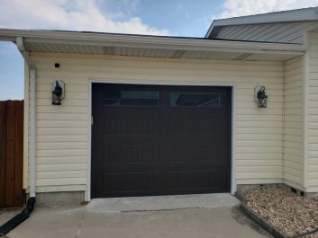 Black Residential Sectional Garage Door after installation with Overhead Door Company of Rapid City.