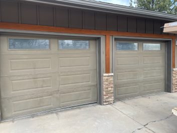 Grey residential sectional garage door with glass before installation