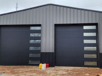 After of two large garage doors with side glass pieces.